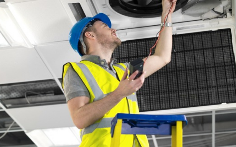 Commercial electrician performing facility work